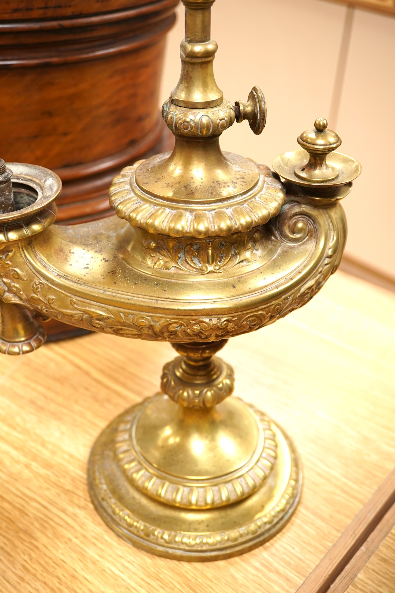 A brass ‘oil lamp’ lamp base and a polychrome painted wood pillar, 75cm